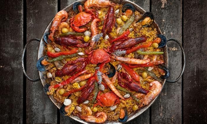 Seafood paella in rustic pan, Creole-inspired coastal feast