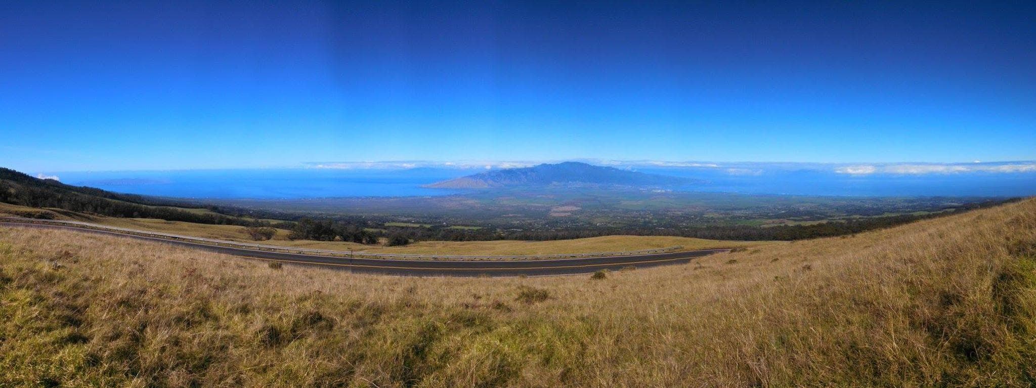 Panoramic volcanic grassland vista ideal for sunrise bike tours