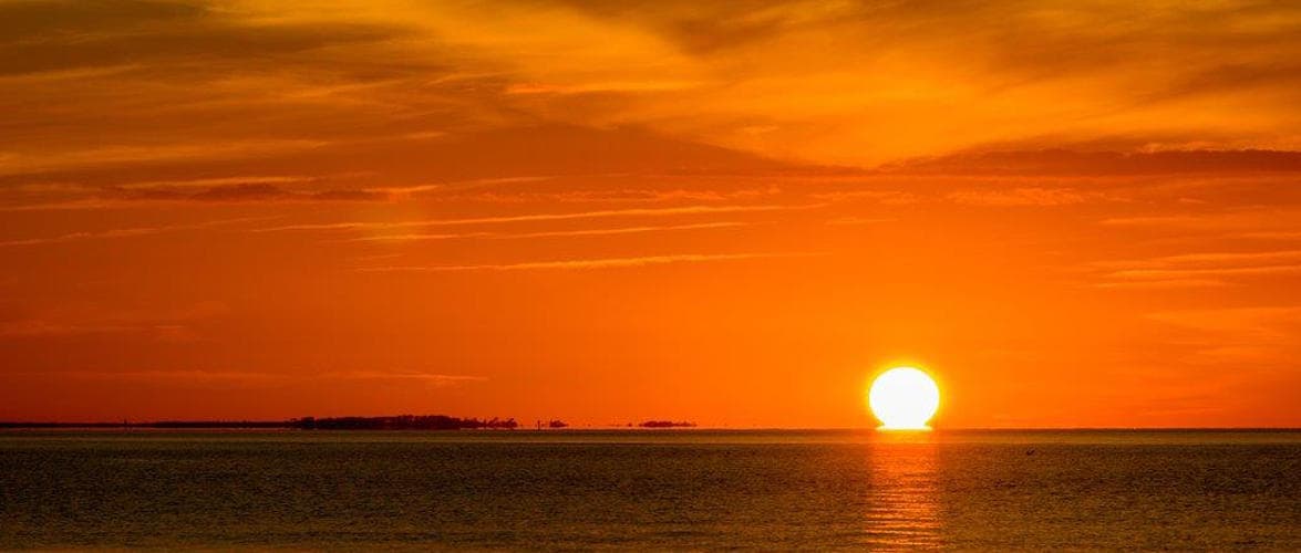 Golden sunset over Outer Banks horizon ideal for scenic cruises