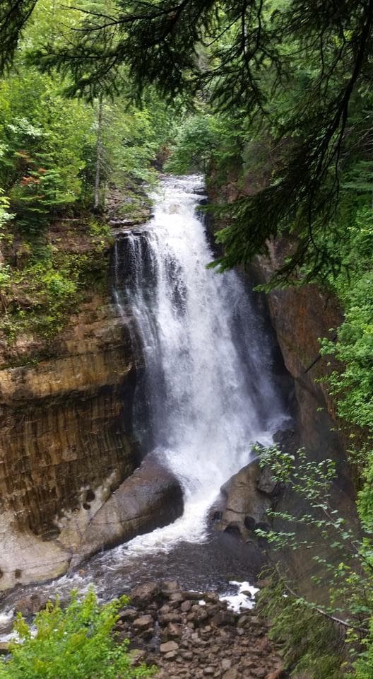 Tall waterfall cascading in Finger Lakes gorge at hiking spot