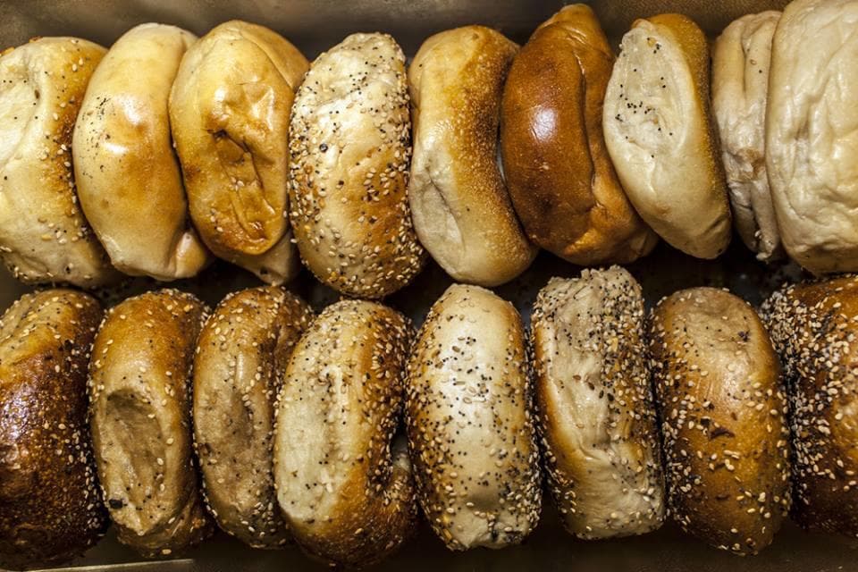 Assorted New York bagels displayed in bakery box on food tour