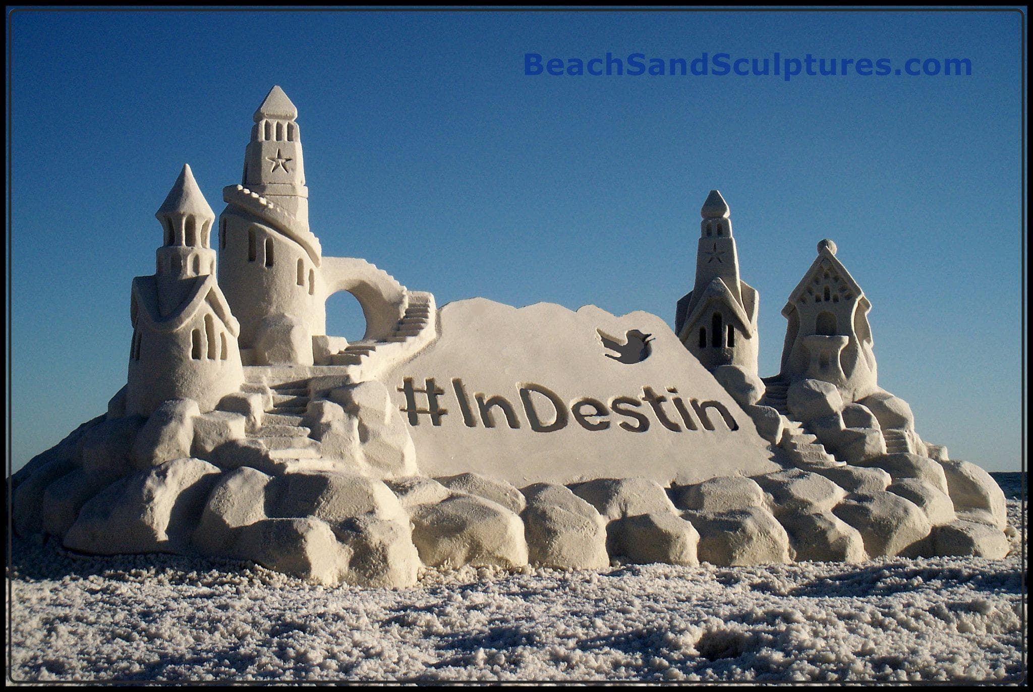 Large sculpted sandcastle on Destin beach with clear sky