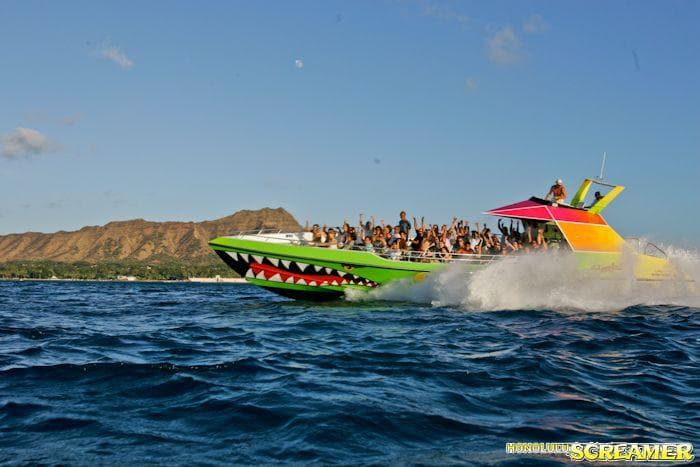 High-speed thrill boat tour cutting across blue ocean waters