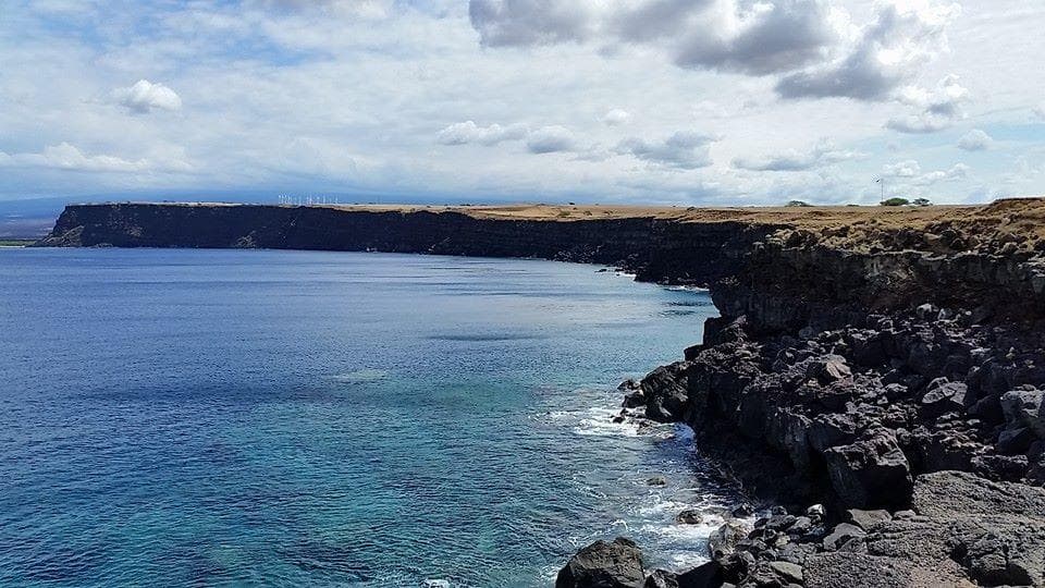 Panoramic coastal cliff view with expansive ocean horizon