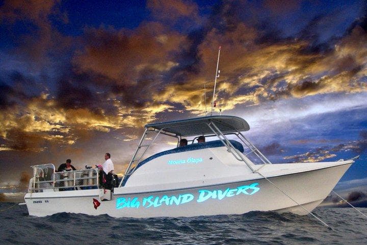 Big Island Divers boat at sea under dramatic sunset sky