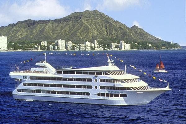 Cruise yacht sailing near Diamond Head coastal skyline in Oahu