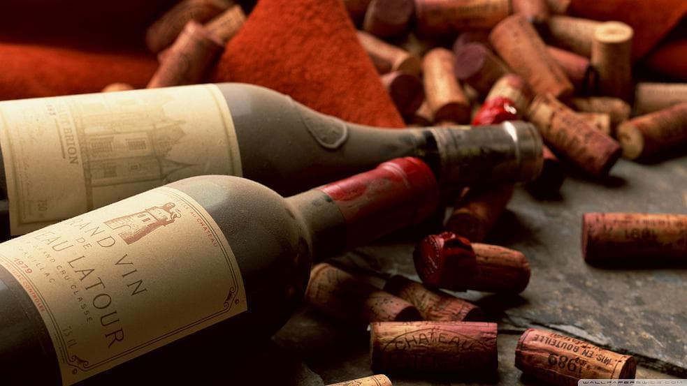 Vintage wine bottles and corks on tasting table for cellar tours