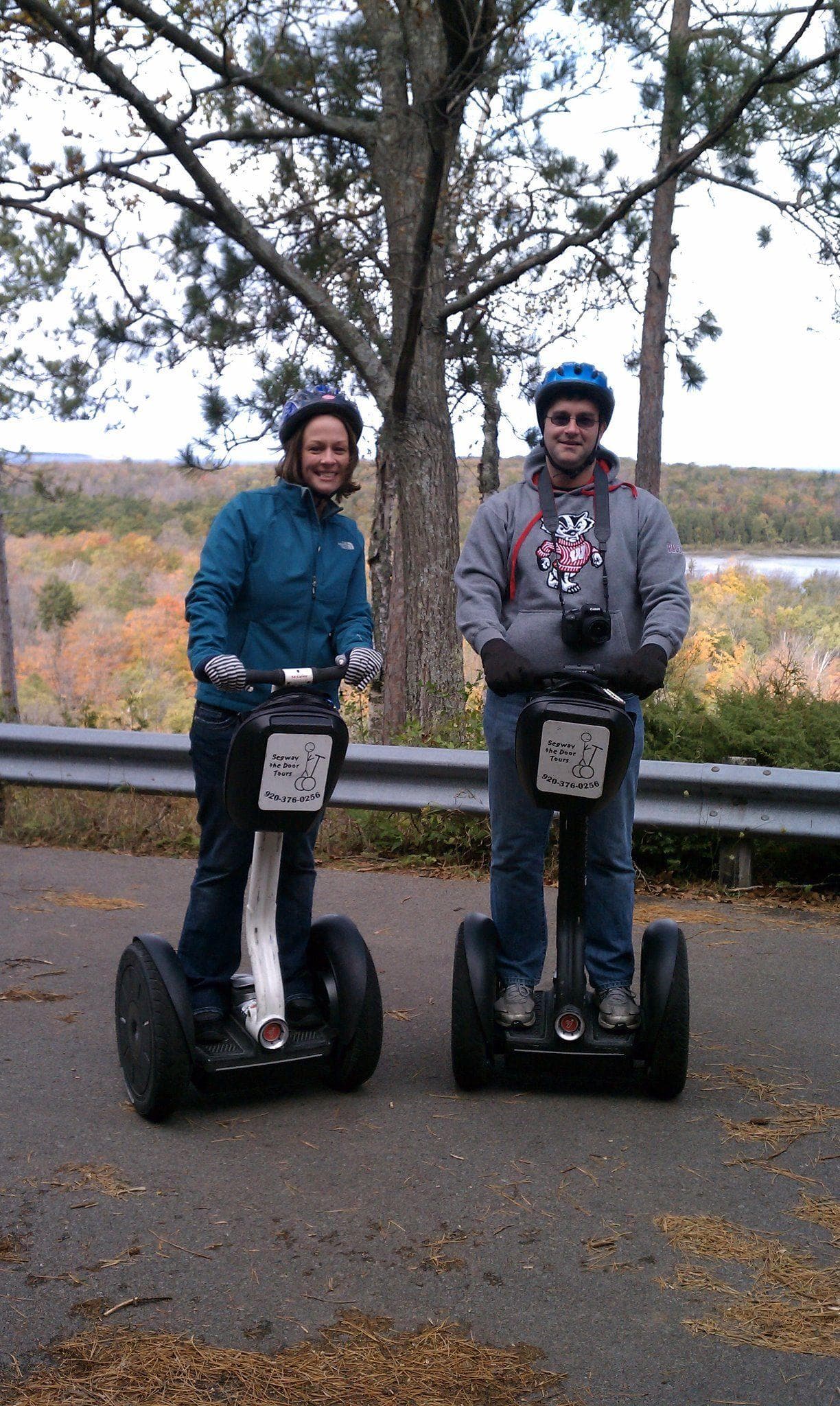 Guided Segway group cruising grassy park with pavilion and skyline