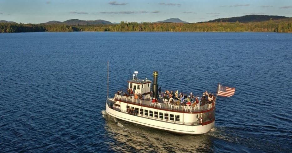 Aerial tour boat cruising Raquette Lake with passengers