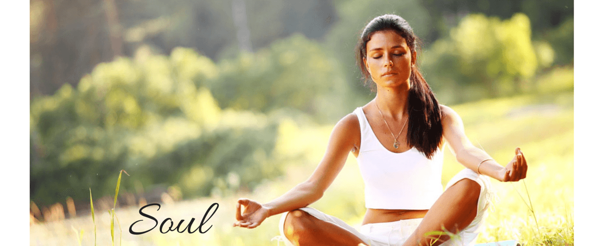 Woman meditating cross-legged in sunny park for mindful outdoor yoga