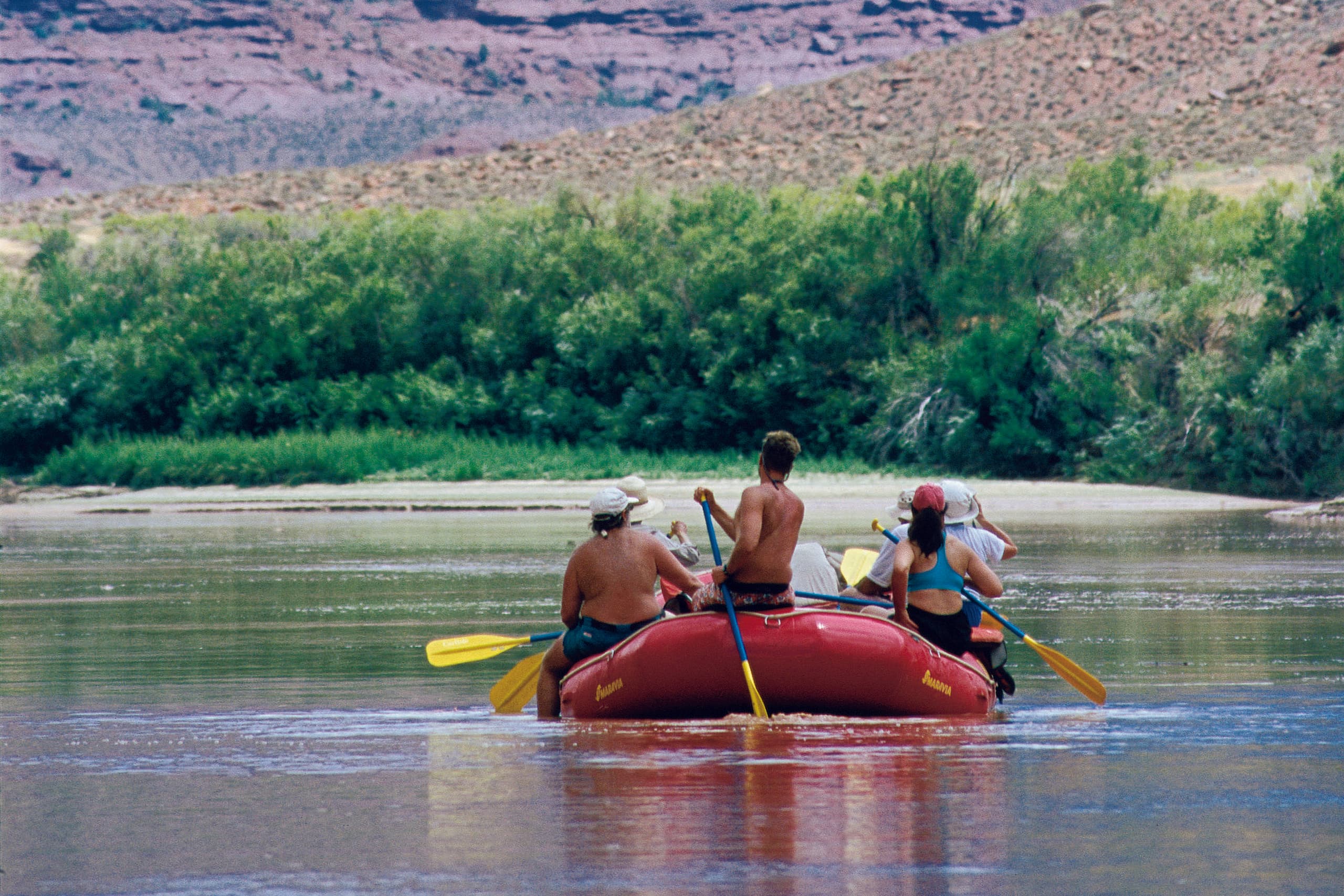 Guided rafting trip on scenic desert river through canyonlands
