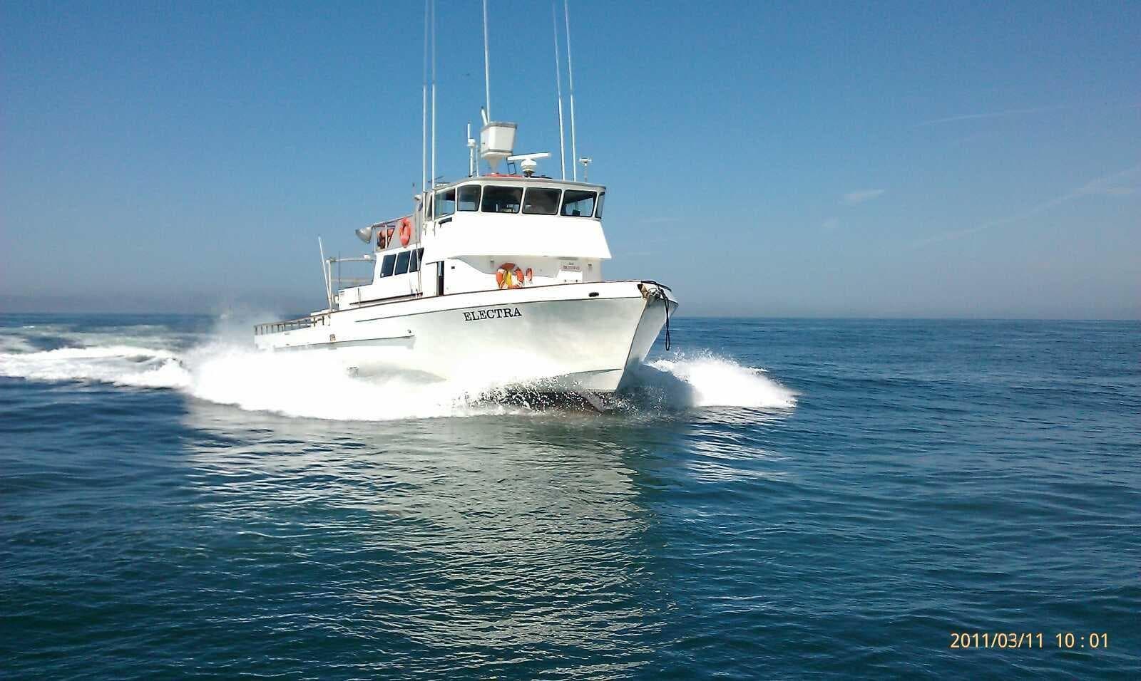 Sportfishing boat cruising offshore in sunny Pacific waters
