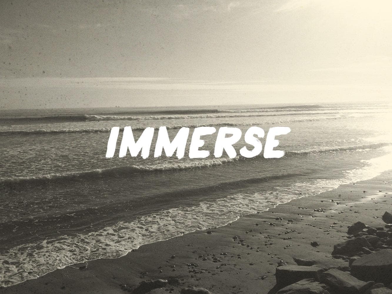 Waves rolling onto rocky shoreline, ocean immersion and surf vibe