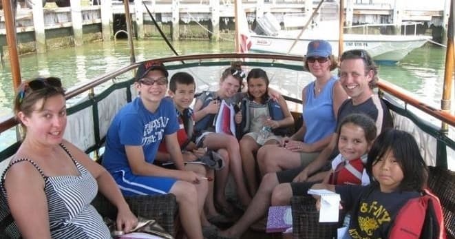 Group of passengers enjoying narrated launch tour on calm water