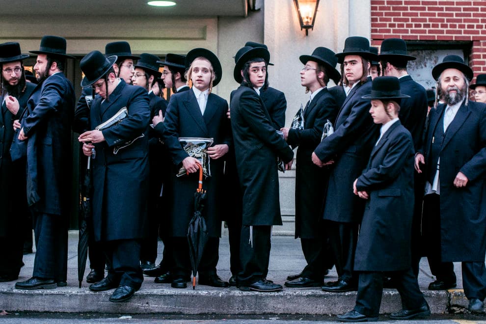 Orthodox men gathered outside synagogue on urban walking tour
