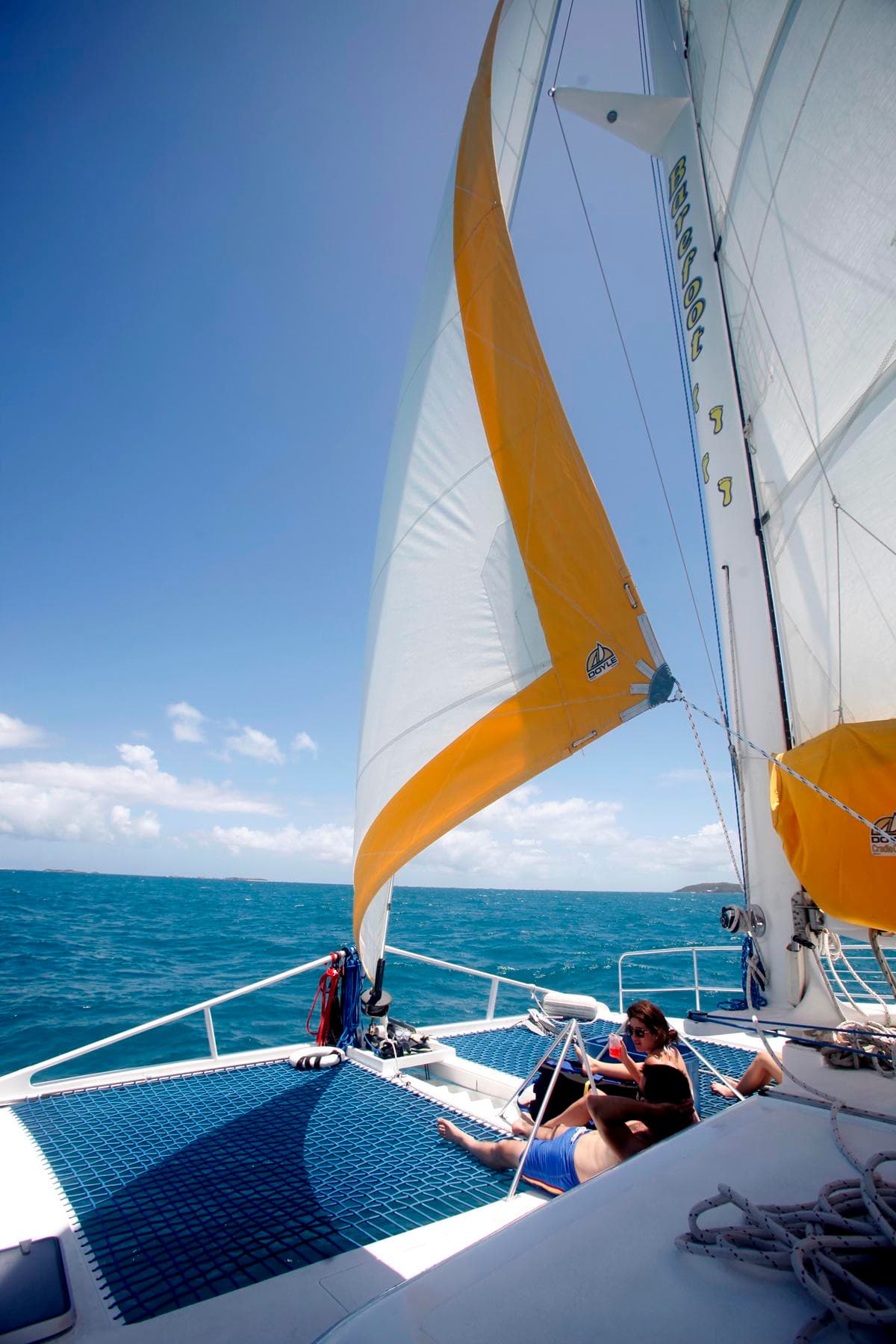 Sailboat rigging and sail close-up against clear blue sky