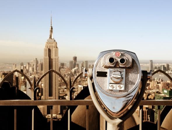 Sightseeing with observation binoculars over NYC skyline view
