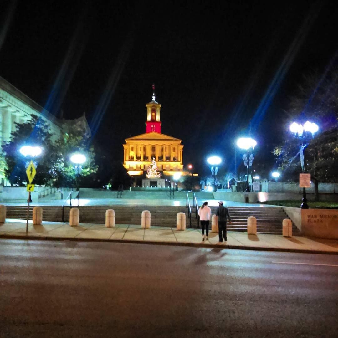 Night view of illuminated capitol building and steps, cityscape