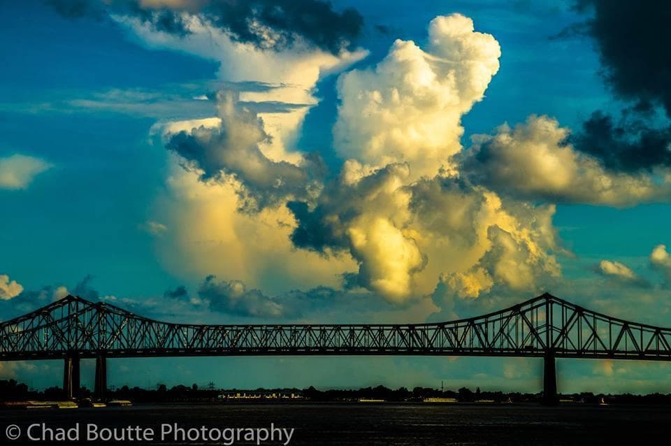 Sunlit dramatic clouds over Mississippi River bridge skyline