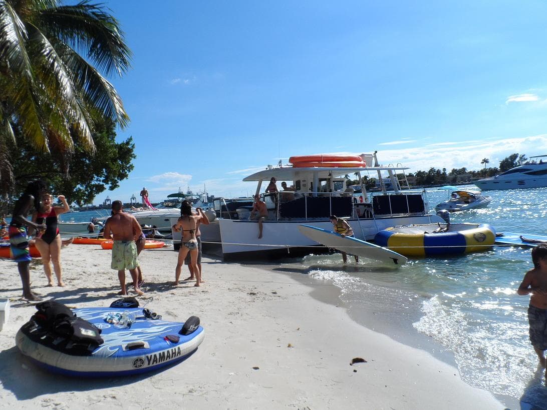 Beach landing with party boat and inflatable water toys on sand