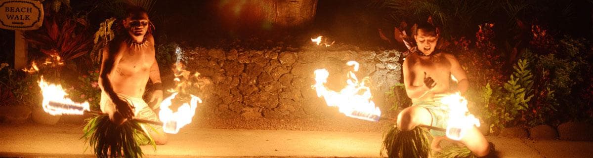 Two fire dancers performing nightly luau show on beach