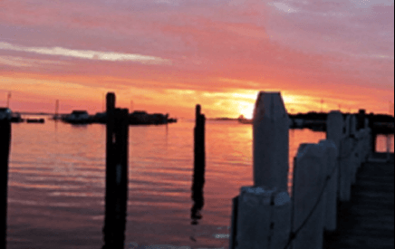 Sunset harbor with wooden pilings at Tangier Island cruise