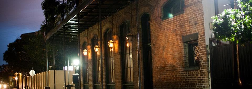 Historic brick street at night with warm lantern lighting
