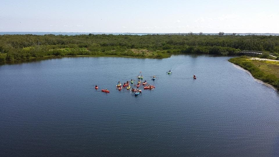 Aerial view of kayakers paddling in coastal lagoon
