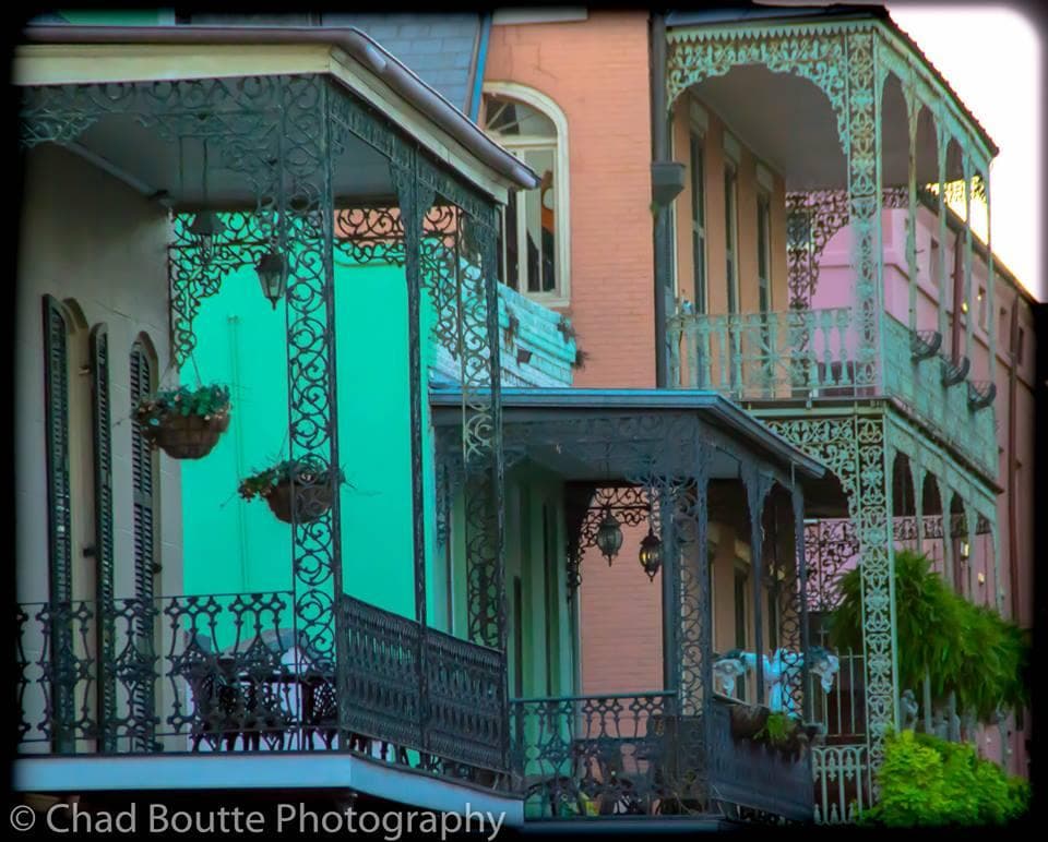 Colorful French Quarter balconies and wrought-iron facades outdoors