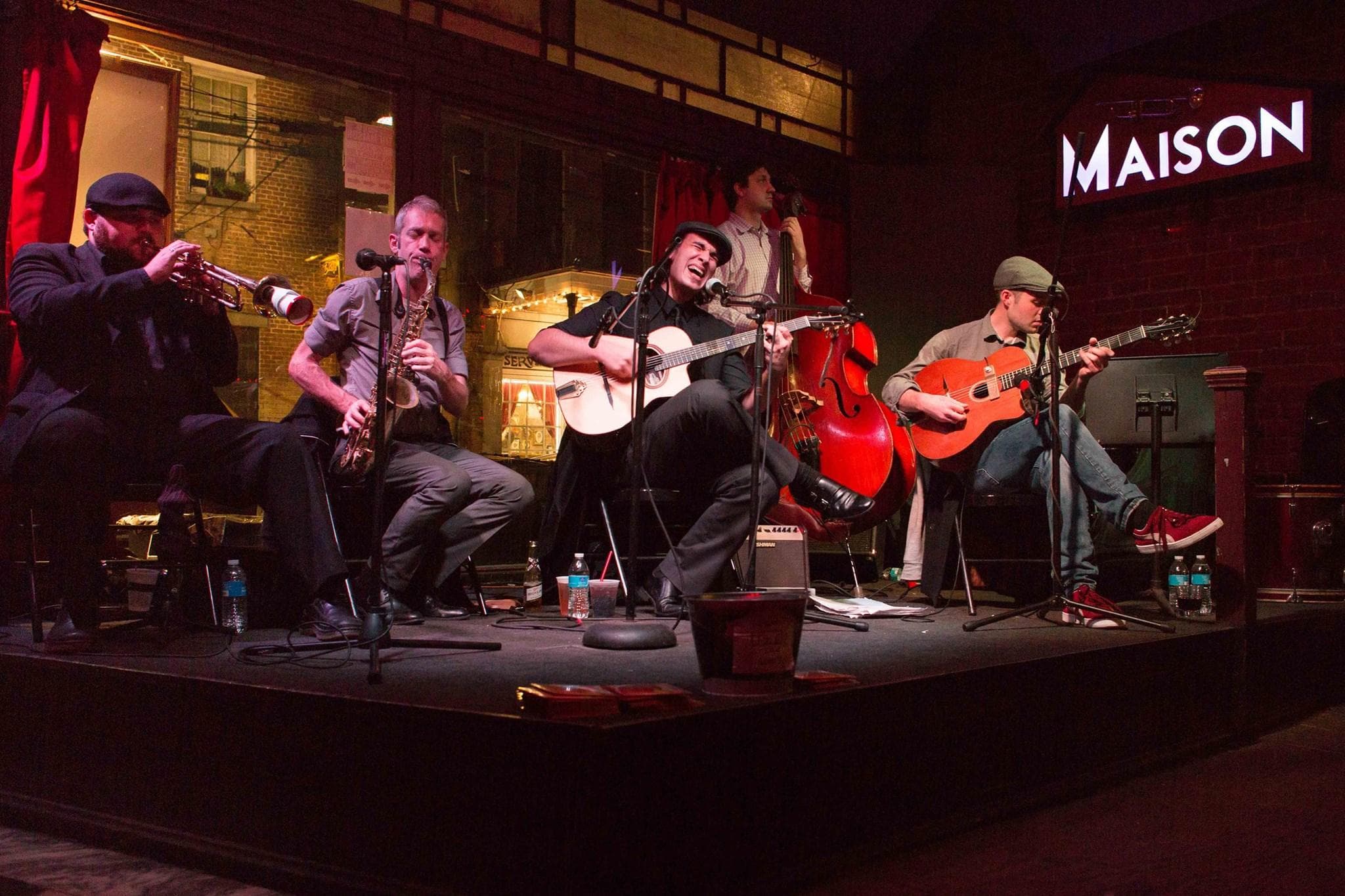 Acoustic band performing on Maison Frenchmen stage at night