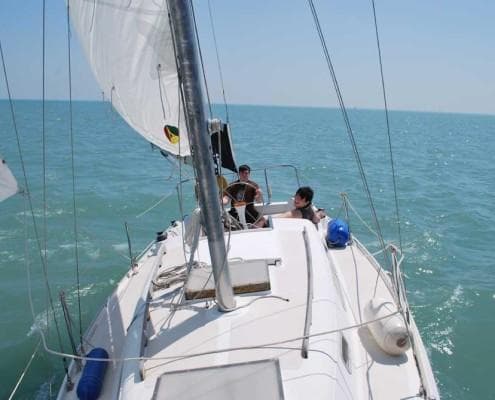Sailing crew on deck navigating open water on Lake Michigan