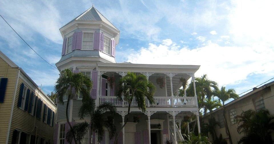 Historic pastel turret house in Key West street view, daytime