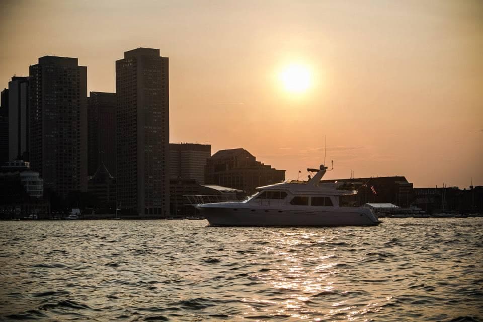 Luxury yacht cruising at sunset on calm coastal harbor waters