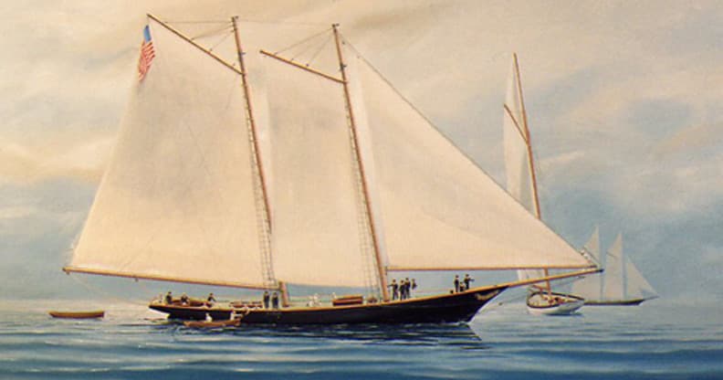 Classic two-masted schooner cruising calm coastal waters