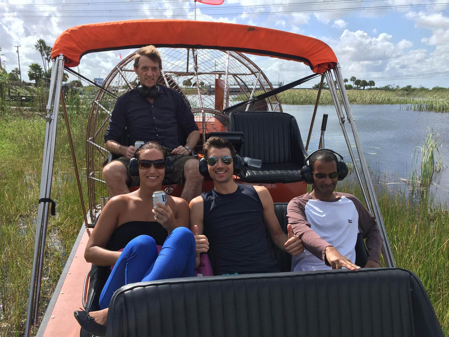 Passengers enjoying an airboat ride through Florida Everglades wetlands