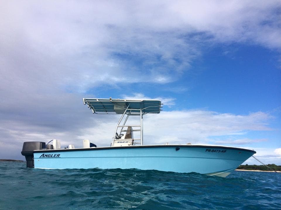 Light blue water taxi boat cruising calm Caribbean waters