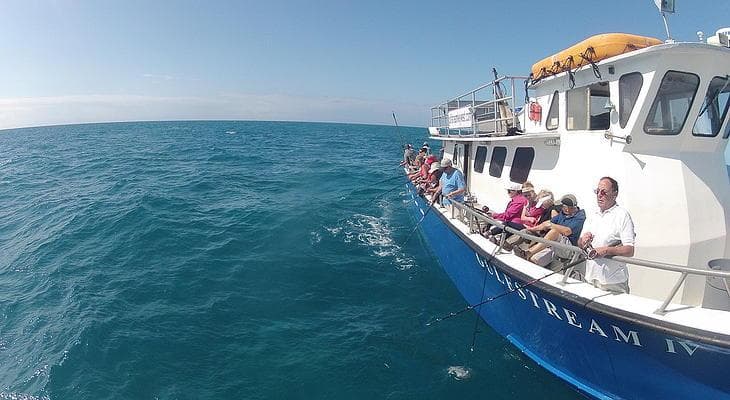 Fishing charter boat cruising turquoise waters off Key West