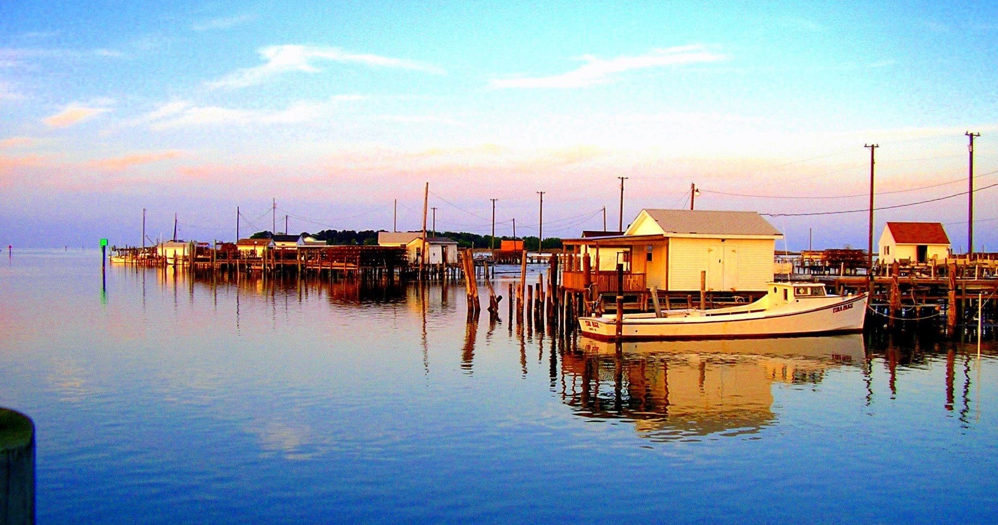 Colorful harbor reflections and skiffs at Tangier Island docks