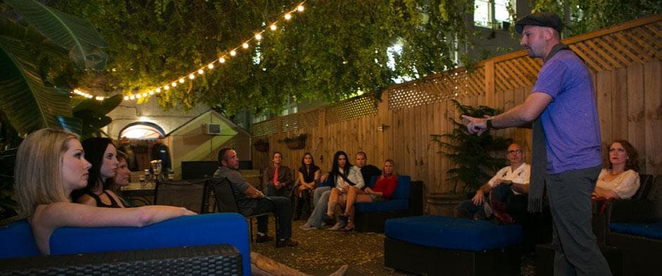 Outdoor patio audience enjoying live performance under string lights