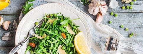 Fresh arugula salad on rustic wooden table, Knoxville food tour