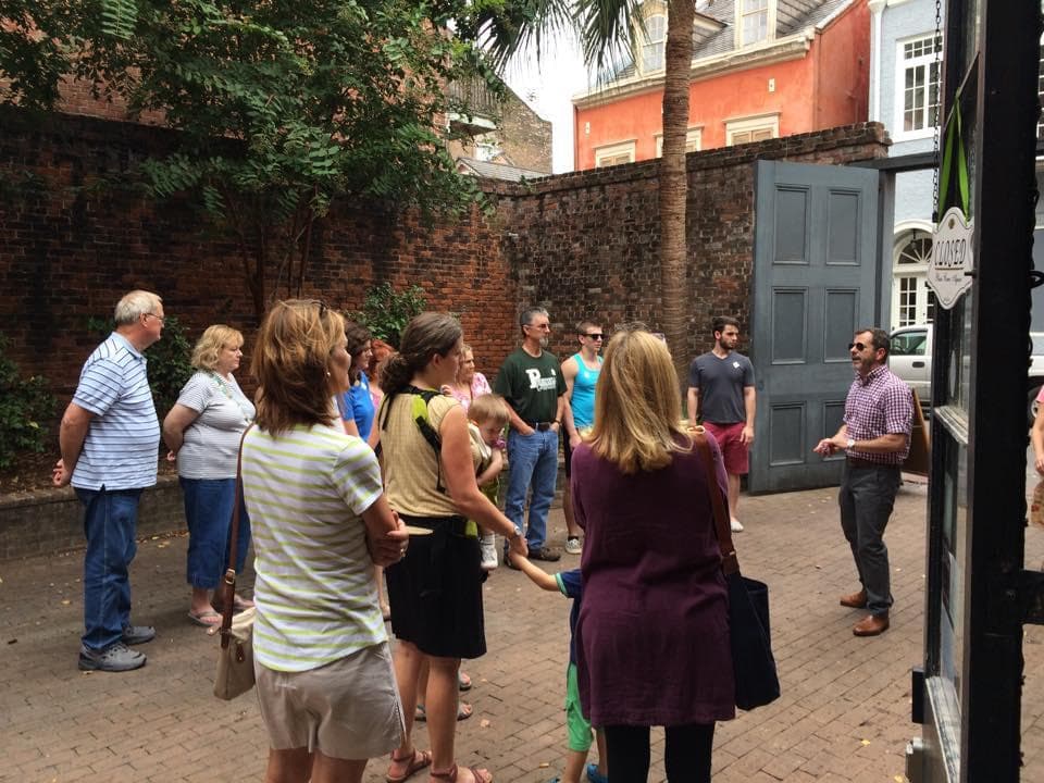 Guided walking tour group listening to guide in historic city alley