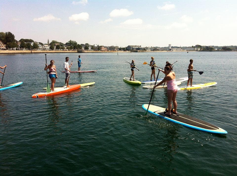 Standup paddlers exploring calm coastal waters near shore