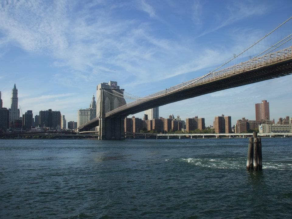 Brooklyn Bridge spanning East River with Manhattan skyline