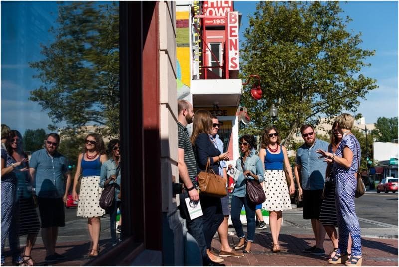 Walking food tour group exploring historic DC neighborhood street