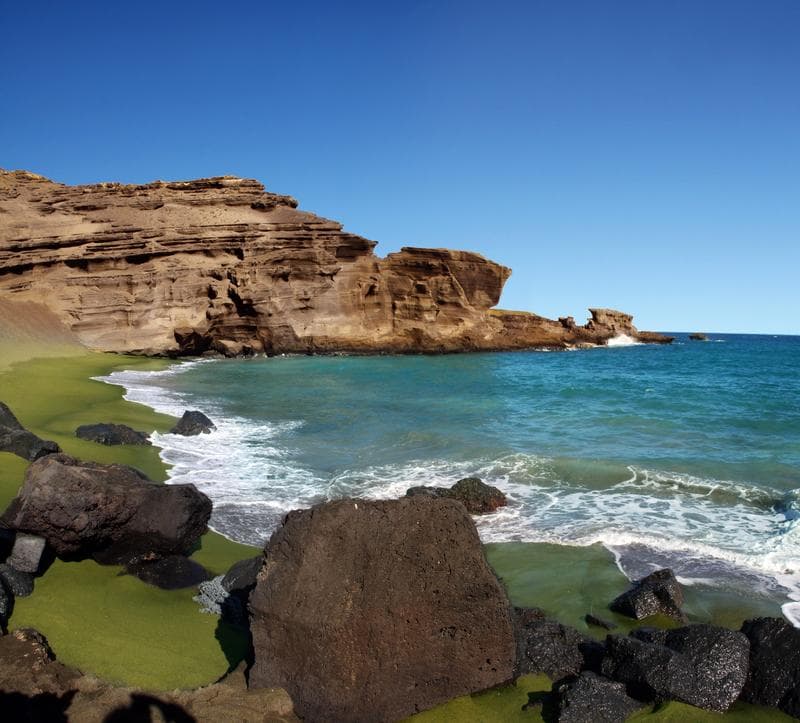 Rocky coastline and turquoise ocean under clear blue sky