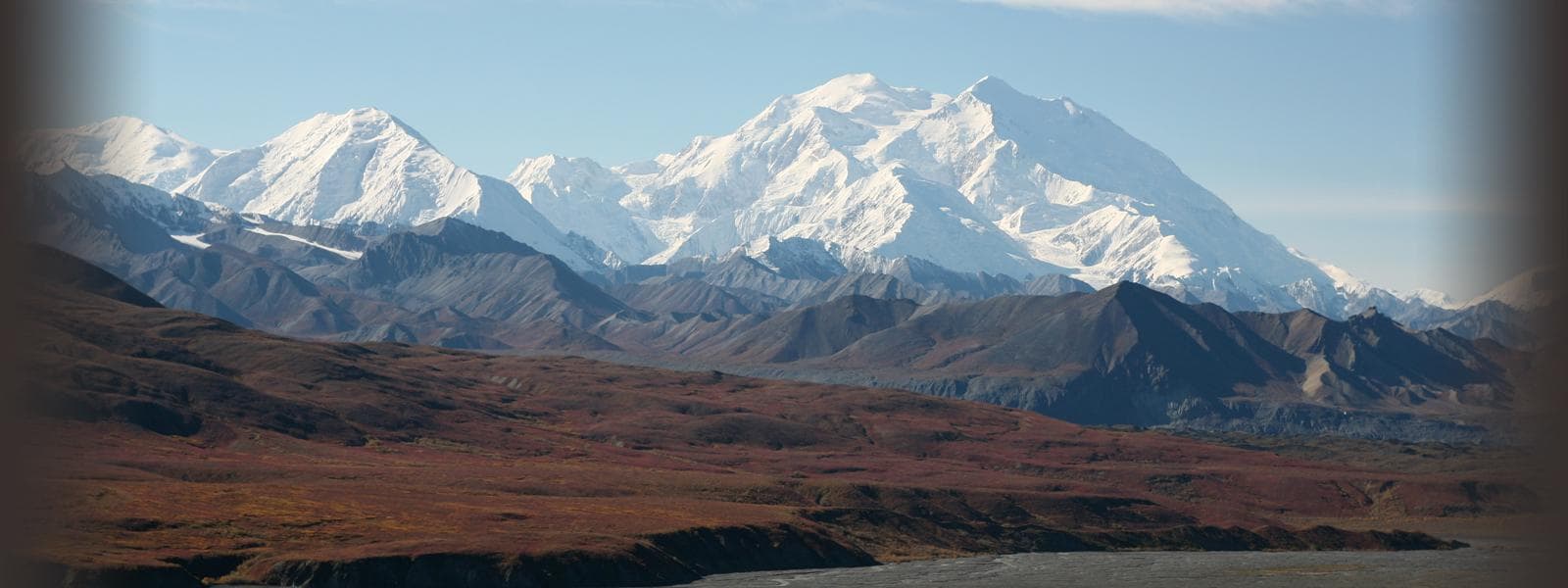 Panoramic Denali mountain range over tundra in Alaska