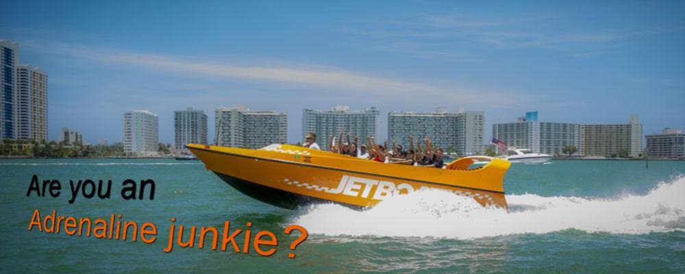 Wide panoramic jet boat speeding past Miami waterfront skyline