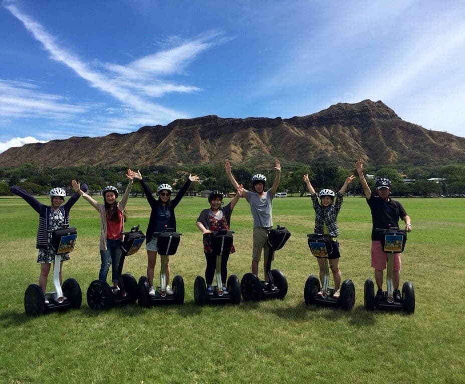 Group riding Segways on Waikiki lawn with Diamond Head view