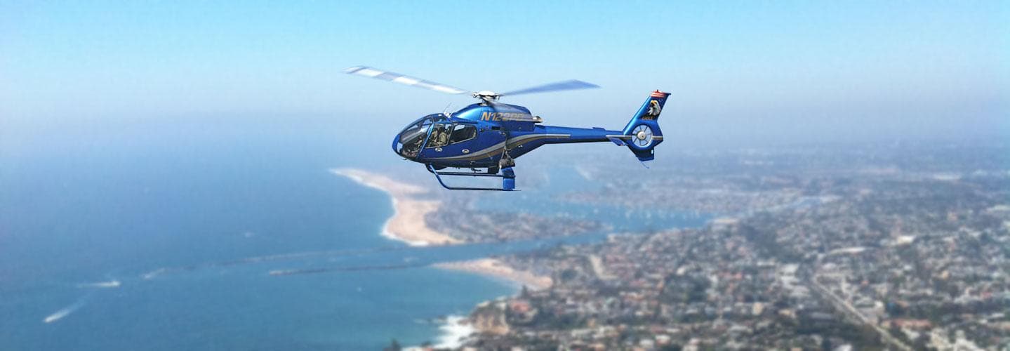 Helicopter sightseeing tour over coastal city and ocean