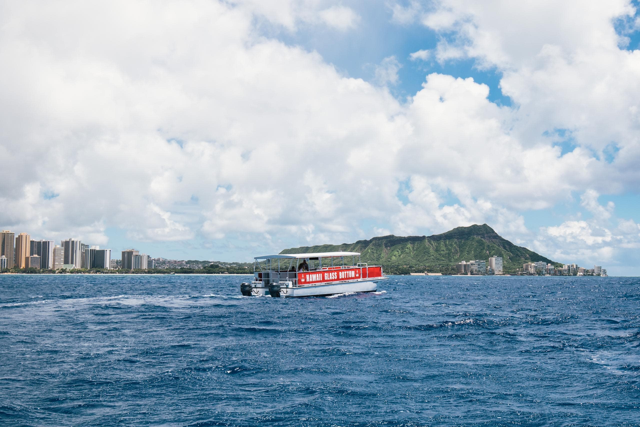 Glass-bottom boat cruising near Diamond Head and Waikiki coast
